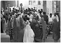 Women in colorful sari in a narrow street during wedding. Jodhpur, Rajasthan, India ( black and white)