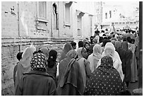 Women in colorful sari walking a  narrow street during wedding. Jodhpur, Rajasthan, India ( black and white)