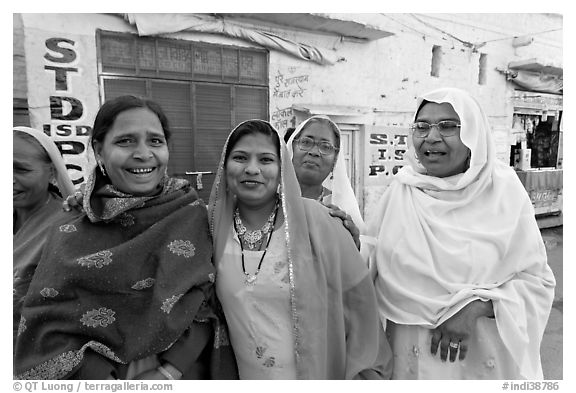 Women wearing hijabs smiling in the street. Jodhpur, Rajasthan, India (black and white)
