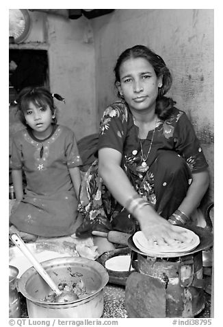 Woman and girl preparing chapati bread. Jodhpur, Rajasthan, India (black and white)