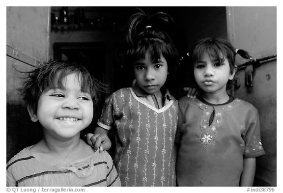 Girls in red dress and blue doors. Jodhpur, Rajasthan, India