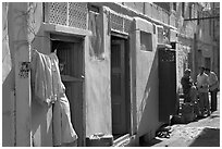 Sunlit street with blue house. Jodhpur, Rajasthan, India ( black and white)