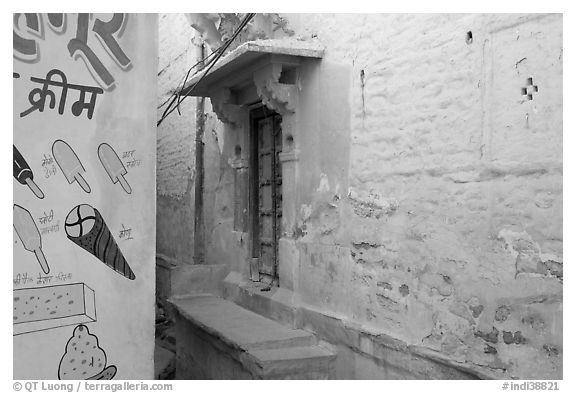 Whitewashed walls with indigo tint and ice-cream depictions. Jodhpur, Rajasthan, India (black and white)