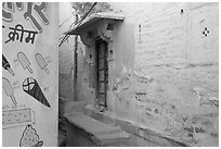 Whitewashed walls with indigo tint and ice-cream depictions. Jodhpur, Rajasthan, India (black and white)