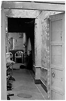 Doorway and inside of a house painted blue. Jodhpur, Rajasthan, India ( black and white)