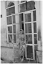 Woman stepping out of door. Jodhpur, Rajasthan, India ( black and white)