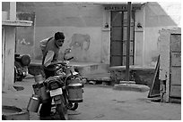 Man with milk delivery motorbike. Jodhpur, Rajasthan, India ( black and white)