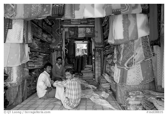 Men in shop selling colorful fabrics, Sardar market. Jodhpur, Rajasthan, India