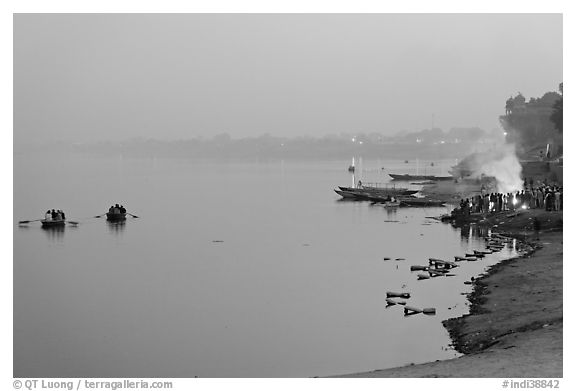 Ganges River at sunset with cremation fire. Varanasi, Uttar Pradesh, India (black and white)