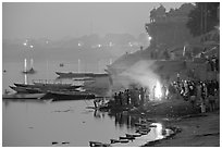 Cremation fire on banks of Ganges River. Varanasi, Uttar Pradesh, India (black and white)