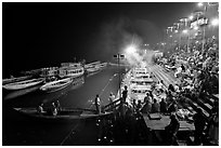 Boat and Dasaswamedh Ghat at the start of evening puja. Varanasi, Uttar Pradesh, India ( black and white)