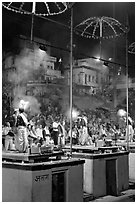 Holy hindu men facing audience during evening arti ceremony. Varanasi, Uttar Pradesh, India (black and white)