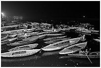 Boats on the Ganges River at night during arti ceremony. Varanasi, Uttar Pradesh, India (black and white)