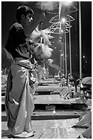 Young Brahman performing arti ceremony. Varanasi, Uttar Pradesh, India (black and white)