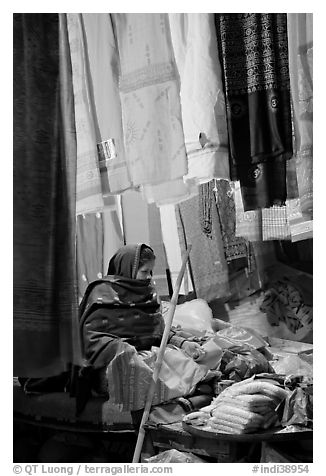Woman selling fabrics at night. Varanasi, Uttar Pradesh, India (black and white)