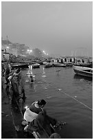 Women soaking clothes in the Ganges River at dawn. Varanasi, Uttar Pradesh, India ( black and white)