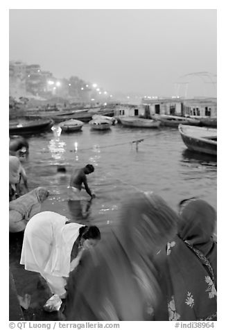 Women on the banks of the Ganga River in rosy dawn light. Varanasi, Uttar Pradesh, India (black and white)