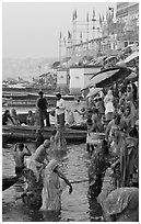 Women standing in Ganga River at sunrise, Dasaswamedh Ghat. Varanasi, Uttar Pradesh, India (black and white)