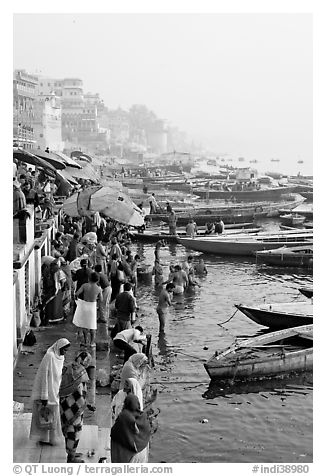 People and boats on the banks of the Ganges River, Dasaswamedh Ghat. Varanasi, Uttar Pradesh, India