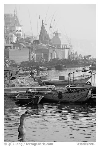 Man with arms stretched standing in Ganga River. Varanasi, Uttar Pradesh, India