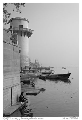 Man sitting on edge of Ganges River. Varanasi, Uttar Pradesh, India (black and white)
