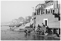 Men dipping in Ganga River at Meer Ghat. Varanasi, Uttar Pradesh, India (black and white)