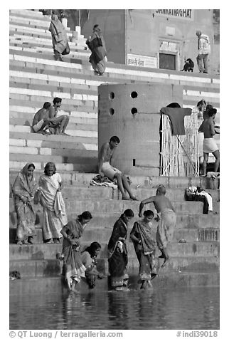 Women dipping feet in Ganga water at Sankatha Ghat. Varanasi, Uttar Pradesh, India