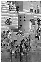 Women dipping feet in Ganga water at Sankatha Ghat. Varanasi, Uttar Pradesh, India ( black and white)