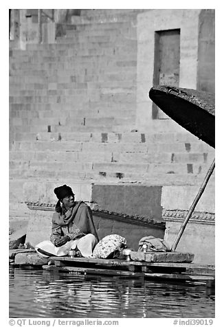 Man sitting near unbrella. Varanasi, Uttar Pradesh, India (black and white)