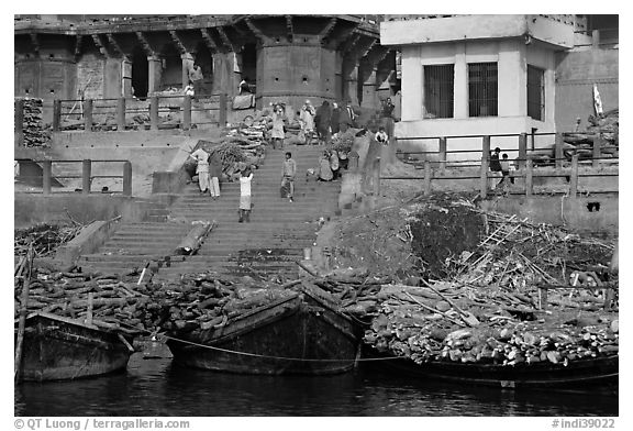 Steps of Manikarnika Ghat with body swathed in cloth and firewood piles. Varanasi, Uttar Pradesh, India (black and white)
