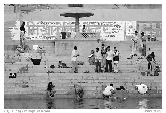 People washing cloths, steps, and Indi inscriptions. Varanasi, Uttar Pradesh, India (black and white)