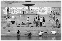 People washing cloths, steps, and Indi inscriptions. Varanasi, Uttar Pradesh, India ( black and white)