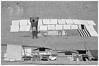 Man laying out laundry for drying. Varanasi, Uttar Pradesh, India (black and white)