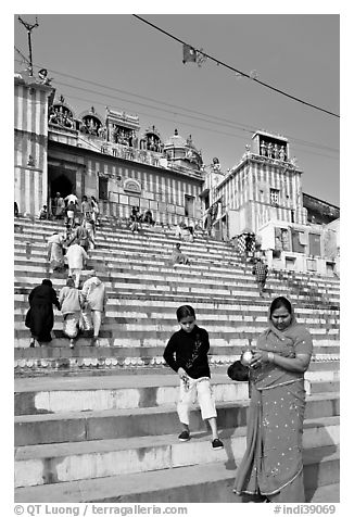 Woman and boy on temple steps, Kedar Ghat. Varanasi, Uttar Pradesh, India