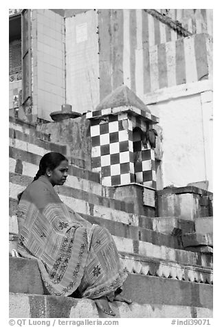 Woman sitting on temple steps. Varanasi, Uttar Pradesh, India