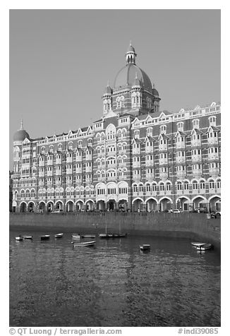 Taj Mahal Palace Hotel and small boats in harbor. Mumbai, Maharashtra, India (black and white)