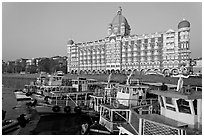 Tour boats and Taj Mahal Palace Hotel. Mumbai, Maharashtra, India (black and white)