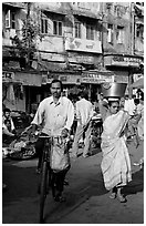 Man riding bike and woman with basket on head, Colaba Market. Mumbai, Maharashtra, India (black and white)