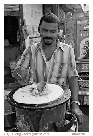 Man preparing breakfast dosa, Colaba Market. Mumbai, Maharashtra, India