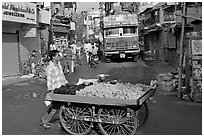 Vegetable vendor pushing cart with truck in background, Colaba Market. Mumbai, Maharashtra, India (black and white)