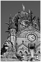Lion and Gothic tower topped by 4m-high statue of Progress, Victoria Terminus. Mumbai, Maharashtra, India (black and white)