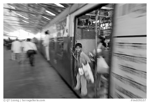 View of departing train with motion blur. Mumbai, Maharashtra, India (black and white)