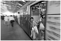 View of departing train with motion blur. Mumbai, Maharashtra, India (black and white)