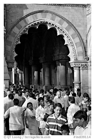 Crowd pass beneath an archway, Chhatrapati Shivaji Terminus. Mumbai, Maharashtra, India