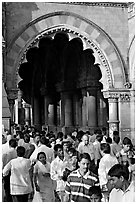 Crowd pass beneath an archway, Chhatrapati Shivaji Terminus. Mumbai, Maharashtra, India (black and white)