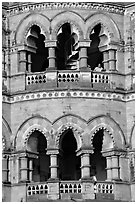 Facade with woman at window, Chhatrapati Shivaji Terminus. Mumbai, Maharashtra, India (black and white)