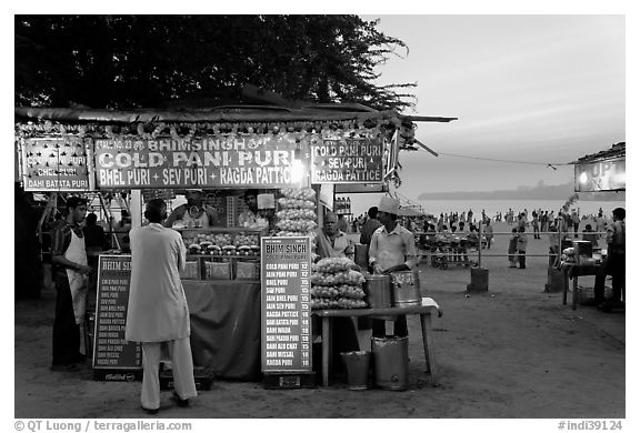 Food kiosks at sunset, Chowpatty Beach. Mumbai, Maharashtra, India (black and white)