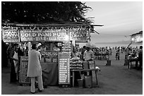 Food kiosks at sunset, Chowpatty Beach. Mumbai, Maharashtra, India (black and white)