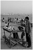 Food vendor on beach at dusk, Chowpatty Beach. Mumbai, Maharashtra, India (black and white)