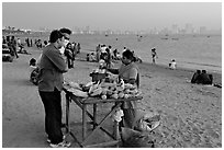 Food stall selling braised corn at twilight,  Chowpatty Beach. Mumbai, Maharashtra, India (black and white)